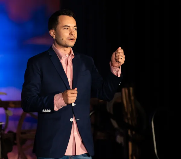 Ryan Vet delivering a keynote on stage Ryan Vet delivering a keynote on stage